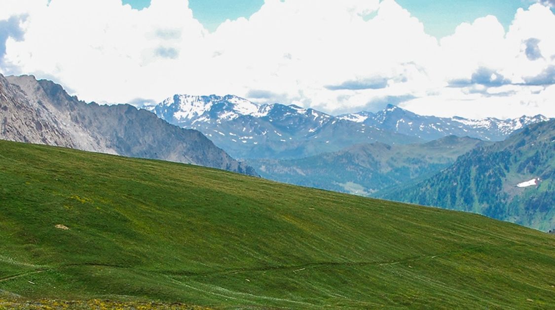 Panoramic view of a man hiking on GR5 hike in Alps