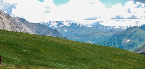 Panoramic view of a man hiking on GR5 hike in Alps