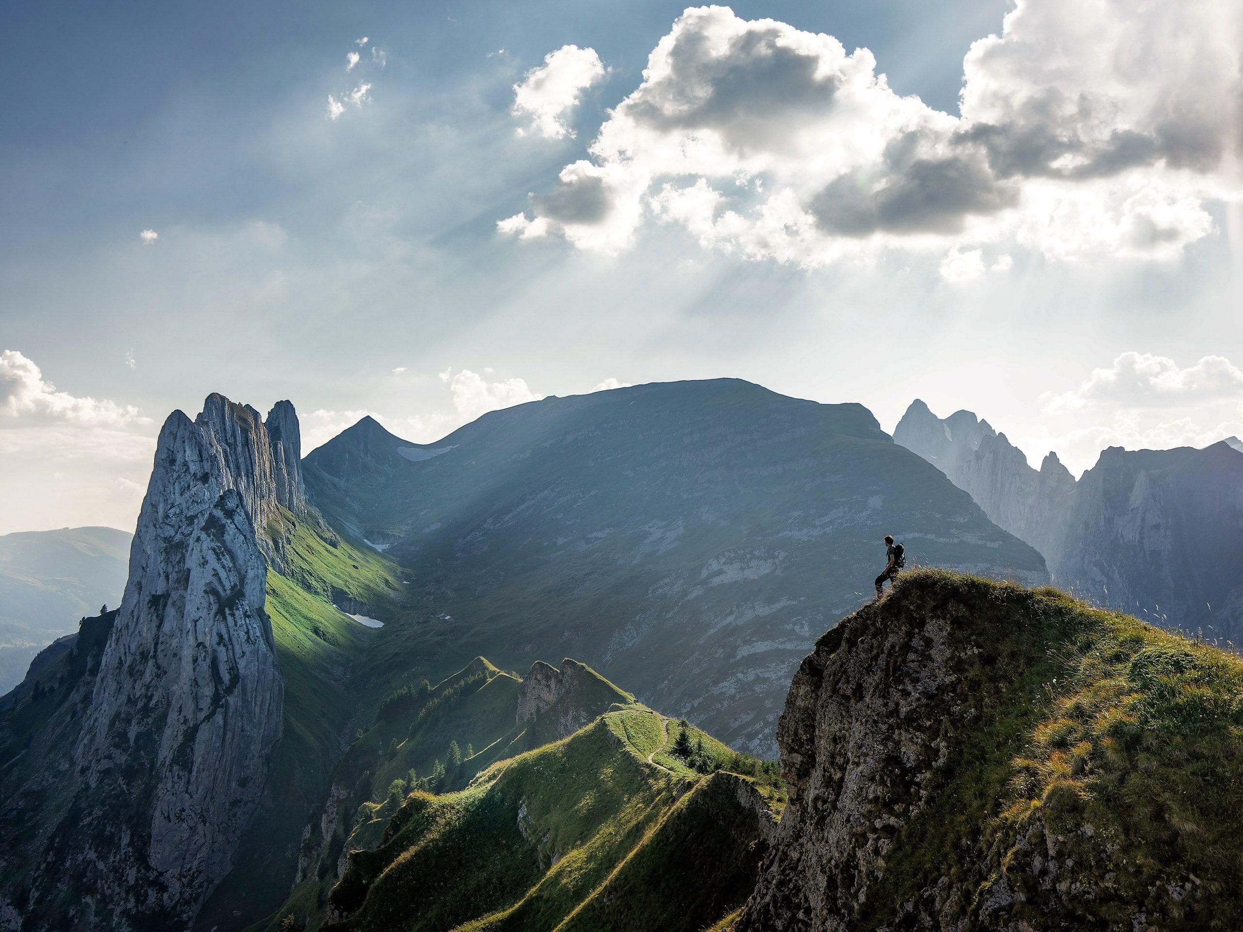 Hiker standing on mountain ridge