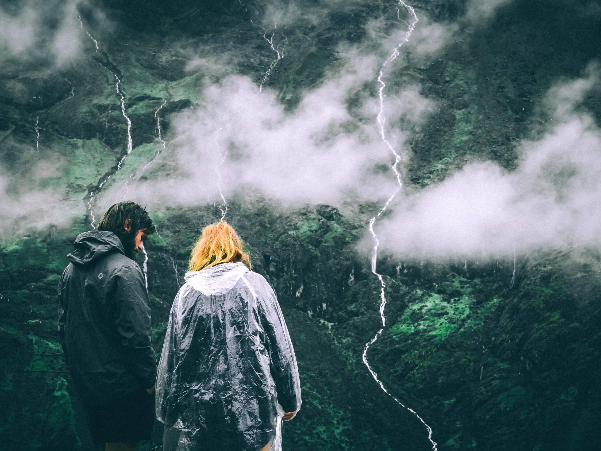 Couple hiking in the mountains during the rain