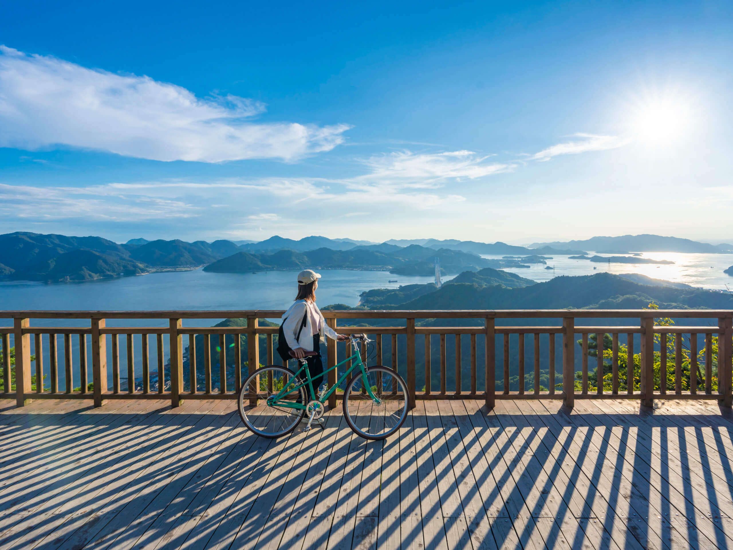 Cyclist enjoying panoramic coastal views in Japan