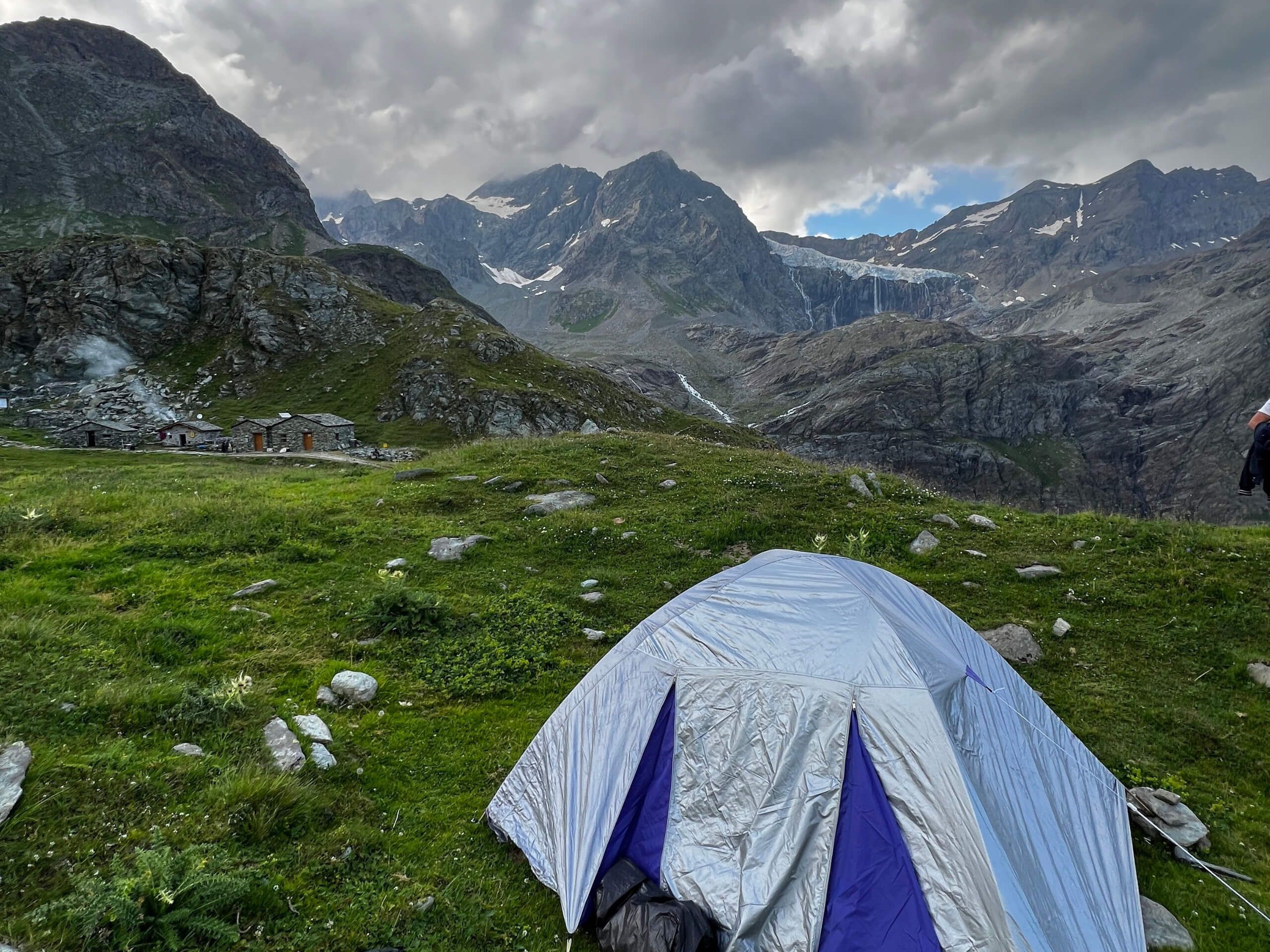 Alpine camping tent near mountain refuge
