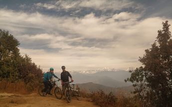 Cyclists Riding Nepal Woodland Trail